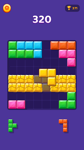 A Block Master board with bright block shapes arranged around a clear grid.